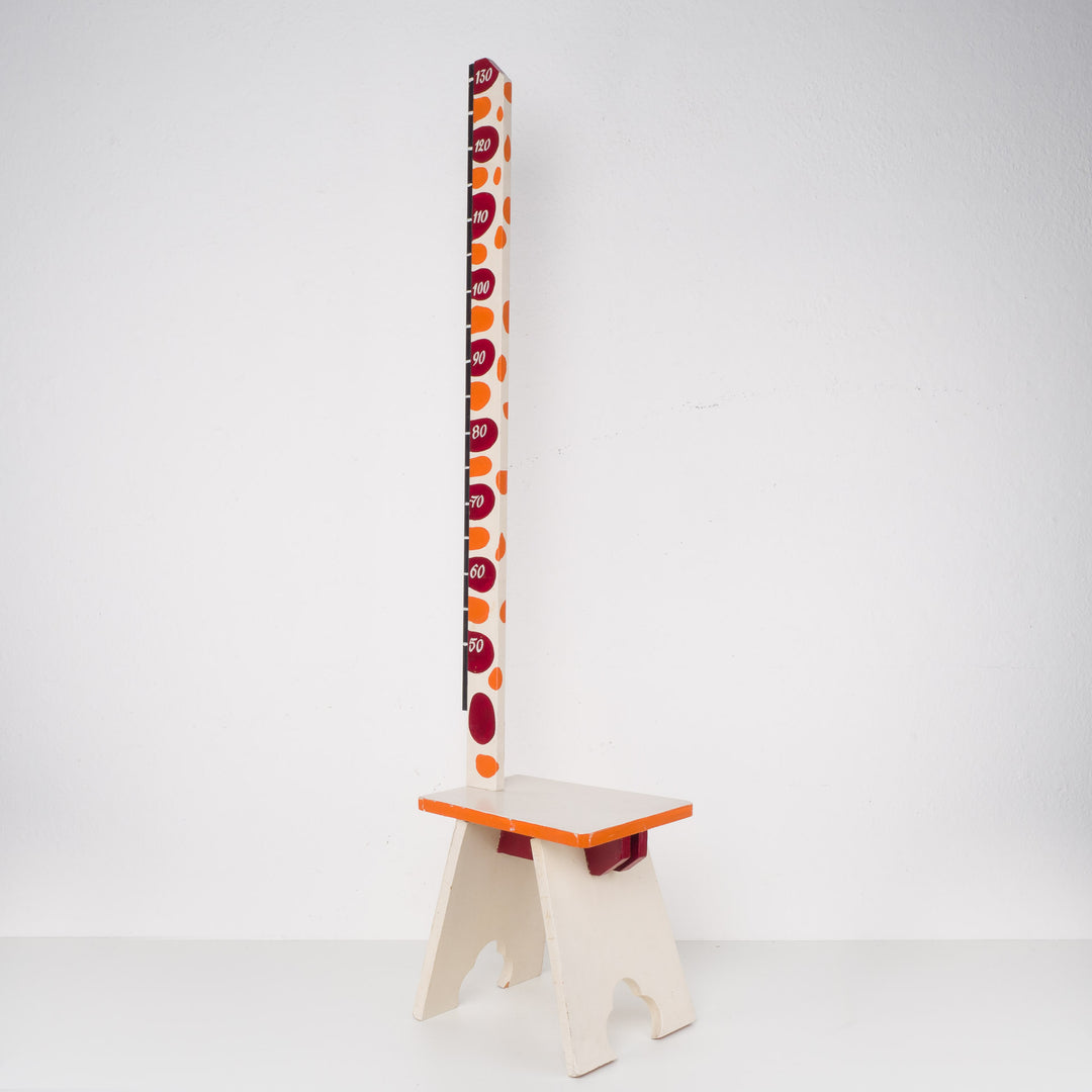 Fun wooden stool with a measuring stick in orange
