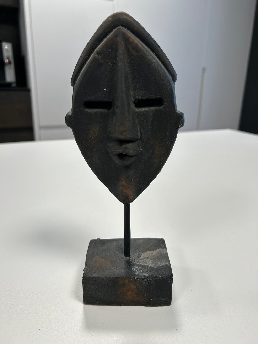 Dark Brown Angular Mask in Stone on Plinth – Mystical Elegance