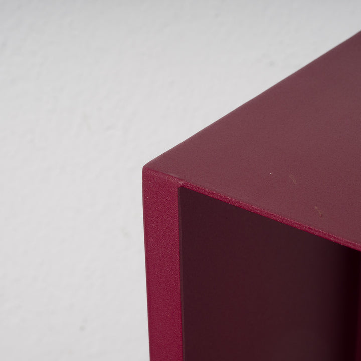 Elongated hollow metal base in burgundy red