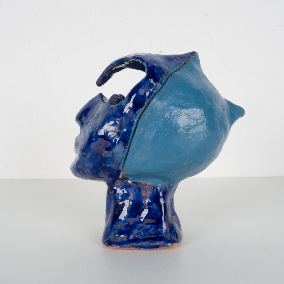 Ceramic face in blue glaze