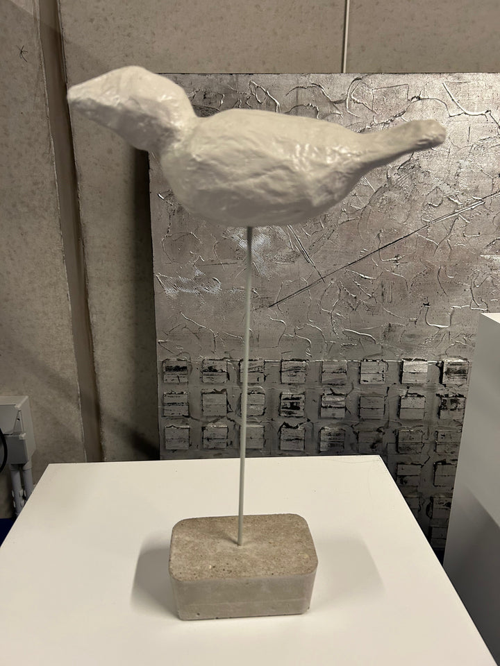 Bird in paper mache on concrete base